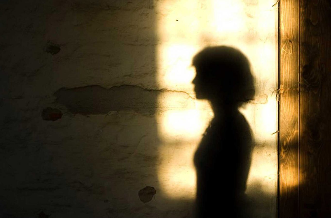 The silhouette of a women against light background.