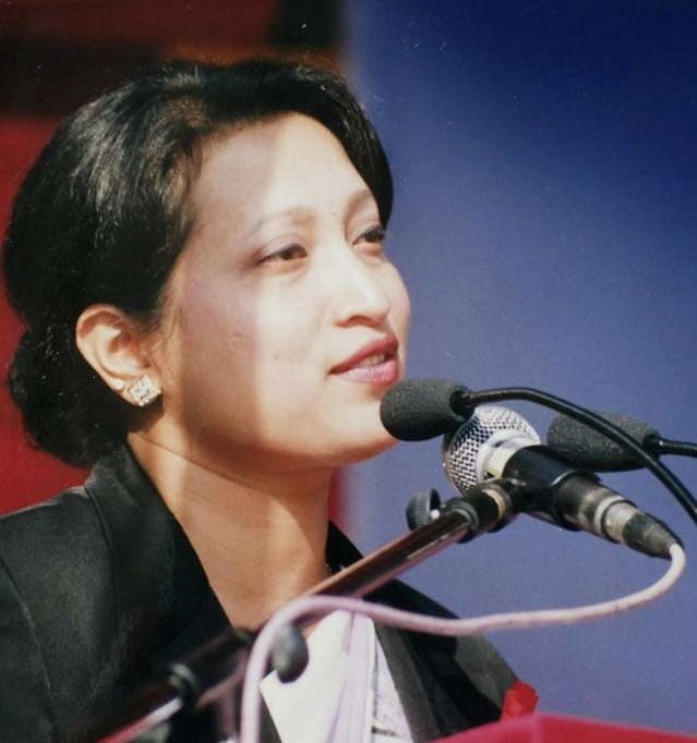 A woman speaks into a microphone.
