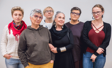 Six women of different age groups look defiantly at the camera.
