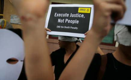 Demonstrators from Amnesty International hold placards outside the Bang Kwang Central Prison to protest against the death penalty in Bangkok, Thailand, June 19, 2018.