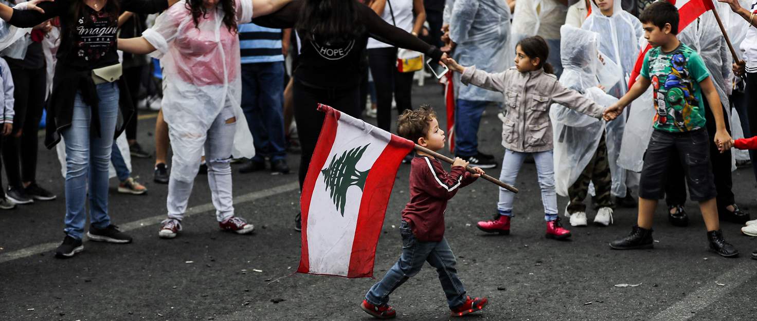 Young boy carries flag