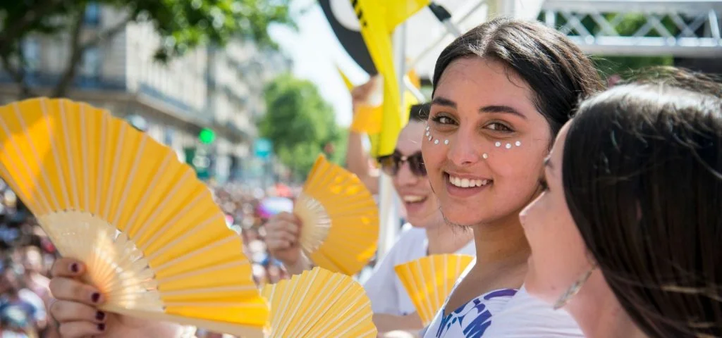 Smiling Amnesty activist holds yellow fan