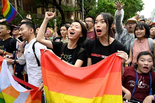 People march and celebrate in the streets of Taiwan, as same-sex marriage is passed on 17 May.