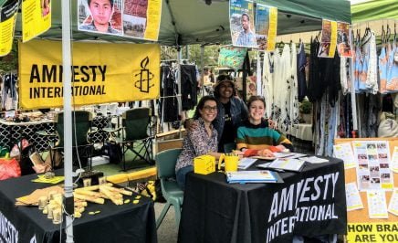 Three women at Amnesty stall in Manly