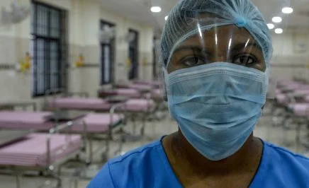 A medical staff wearing a facemask poses in an isolation ward at a newly inaugurated hospital by the Tamil Nadu state during a government-imposed nationwide lockdown as a preventive measure against the COVID-19 coronavirus, in Chennai on March 27, 2020.