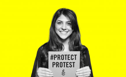 Protect the protest image of young woman smiling at the camera