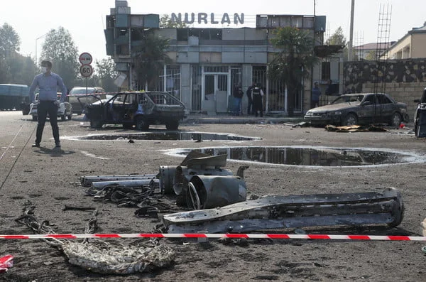 Vehicles damaged in the 28 October 2020 shelling attack in a street. The fighting between Armenia and Azerbaijan over Nagorno-Karabakh resumed in late September with both countries accusing each other of provocation, declaring martial law, and mobilising their armed forces