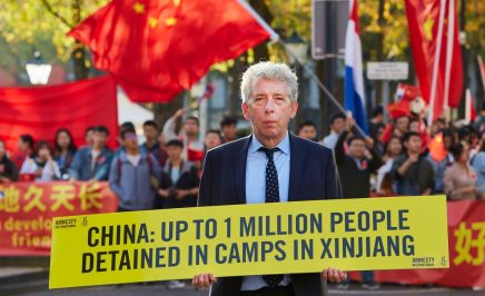 Man standing with sign 