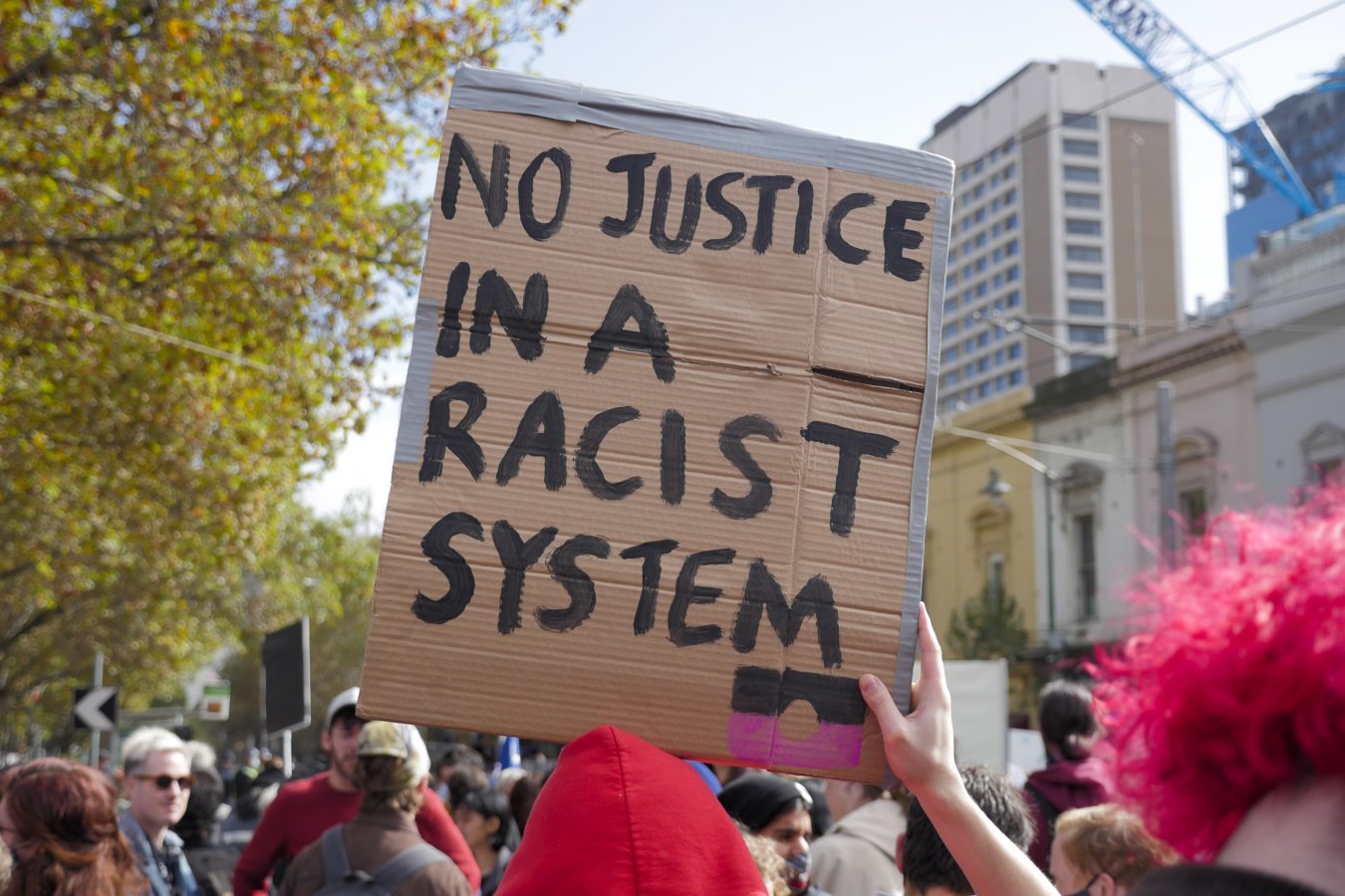Sign reads 'No justice in a racist system' at Black Lives Matter rally, Melbourne, 2021