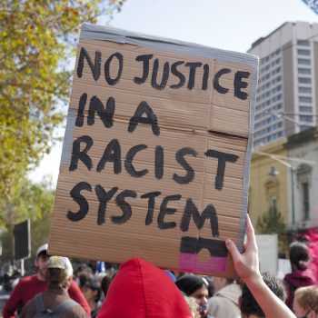 Sign reads 'No justice in a racist system' at Black Lives Matter rally, Melbourne, 2021