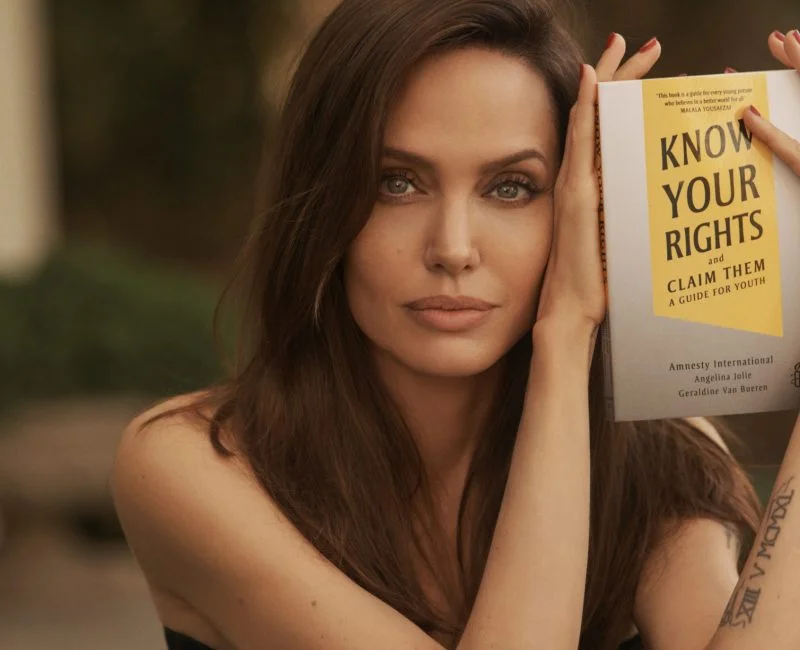 Angelina Jolie with the book 'Know Your Rights and Claim Them'
