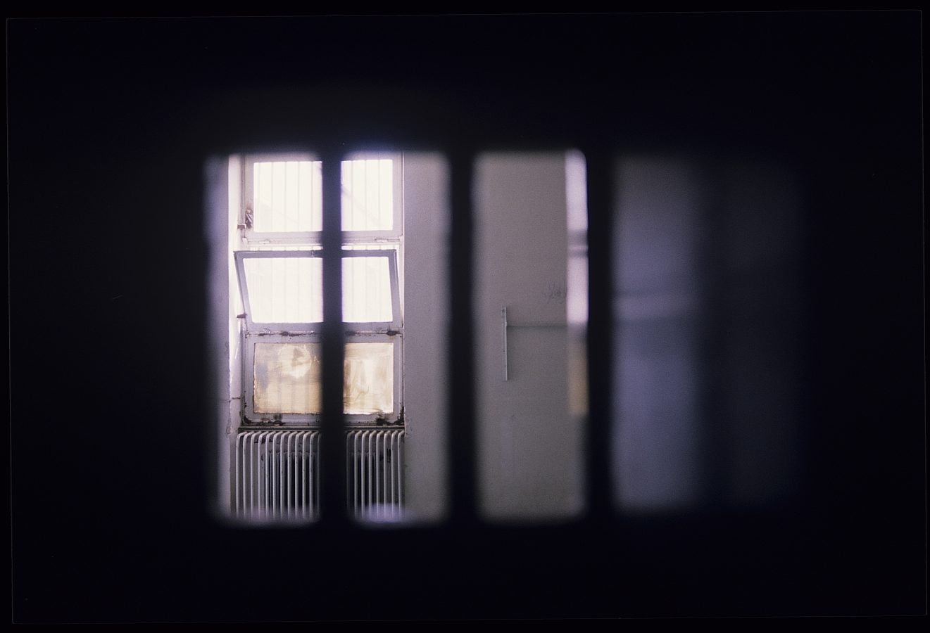 The image of a dark, empty cell inside the political ward at the high security Evin Prison in Tehran, Iran, 10th February 1986.