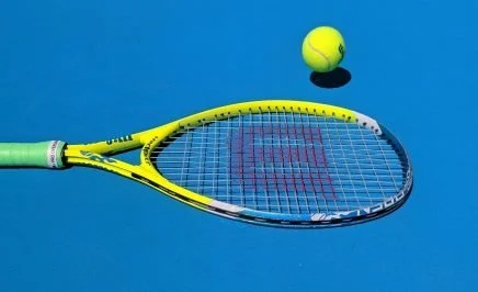 An image of a tennis racket against a blue background.