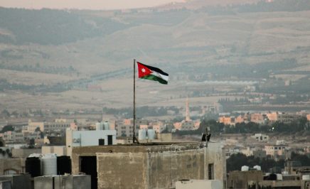 Flag of Jordan flying above a building