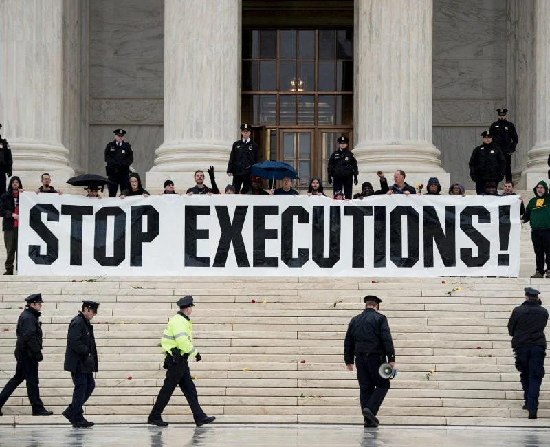 Police officers gather to remove activists during an anti death penalty protest in front of the US Supreme Court