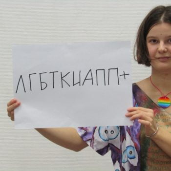 Yulia holds up a sign that says 