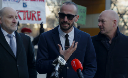 Moz wearing sunglasses, standing out the front of the federal court. to his left is Michael Bradely from marque lawyers, and to his right is Tim Oconner from Amnesty International