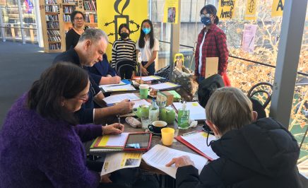 Activists of all ages from the Hornsby Action Group gathered round a table in a bookshop writing letters