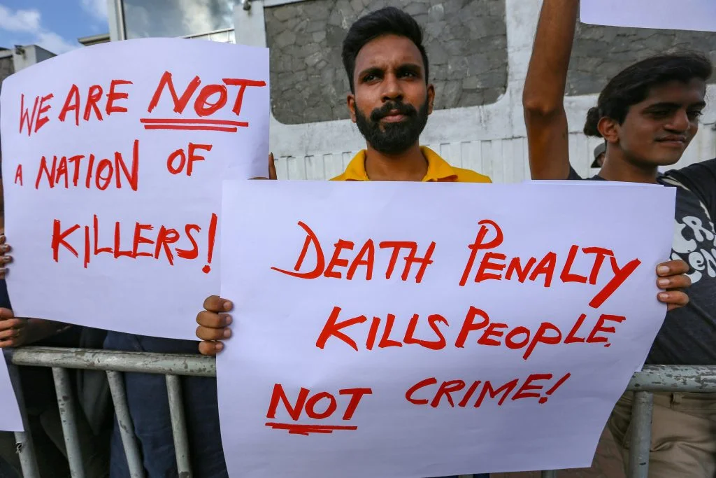 Sri Lankan activists hold placards during a protest against the death penalty in Colombo.