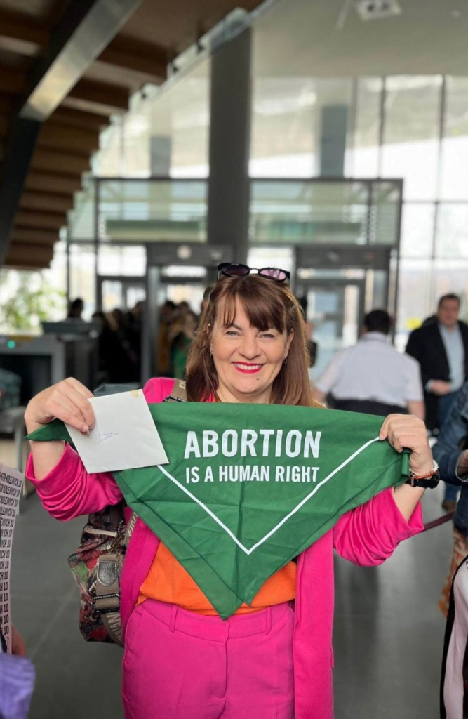 Justyna Wydrzyńska holds a banner with the message 'Abortion is a human right'