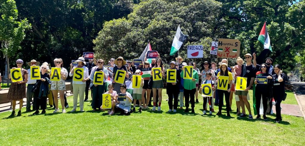 Amnesty activists and supporters gather in Sydney to demand a ceasefire in Gaza.
