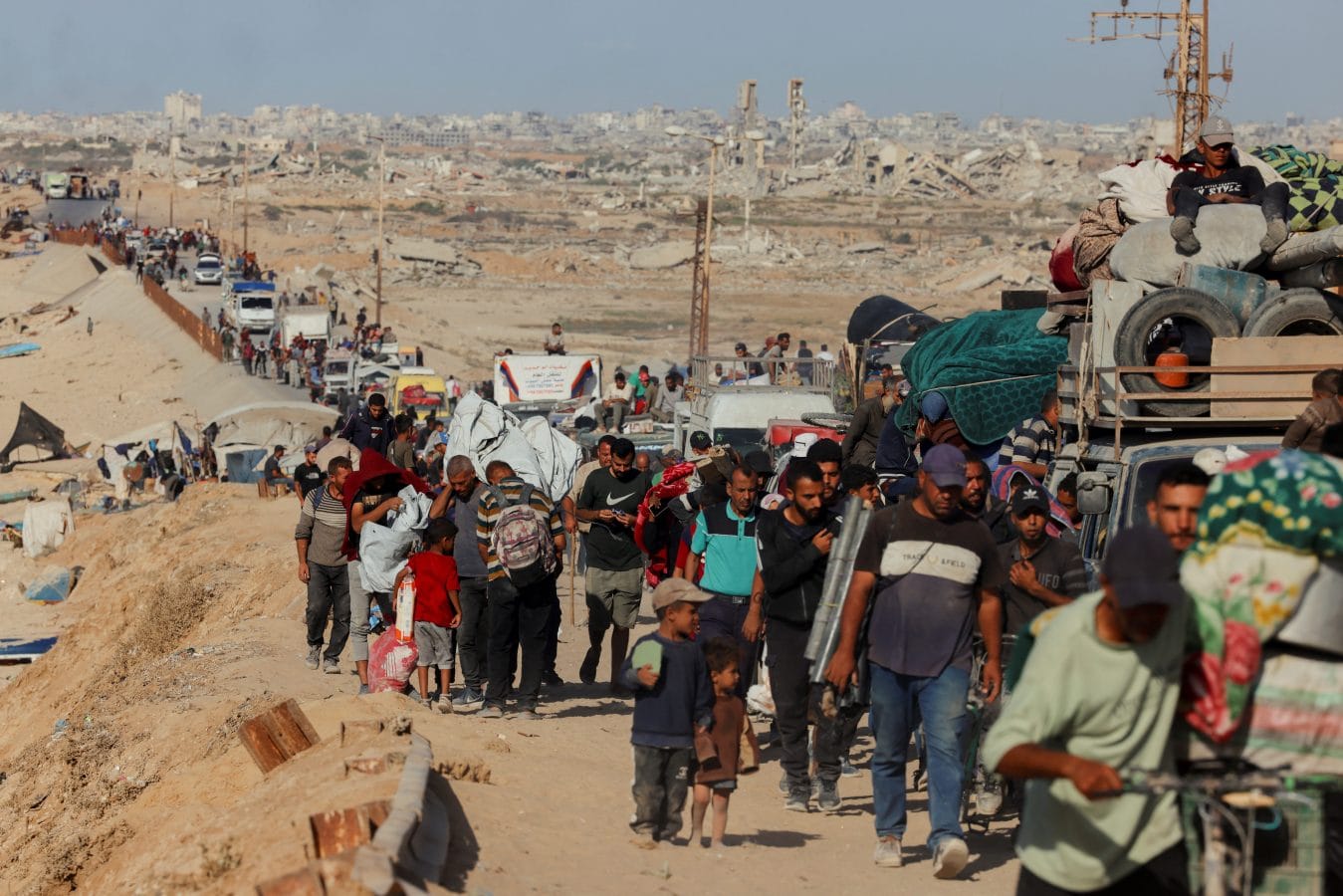 Crowds and vehicles fill a coastal road as displaced Palestinians travel north in the Gaza Strip on October 11, 2025. Many residents have begun moving back to their neighborhoods following the announcement of a ceasefire between Israel and Hamas. (Photo by Abdelrahman Rashad / Middle East Images via AFP) (Photo by ABDELRAHMAN RASHAD/Middle East Images/AFP via Getty Images)