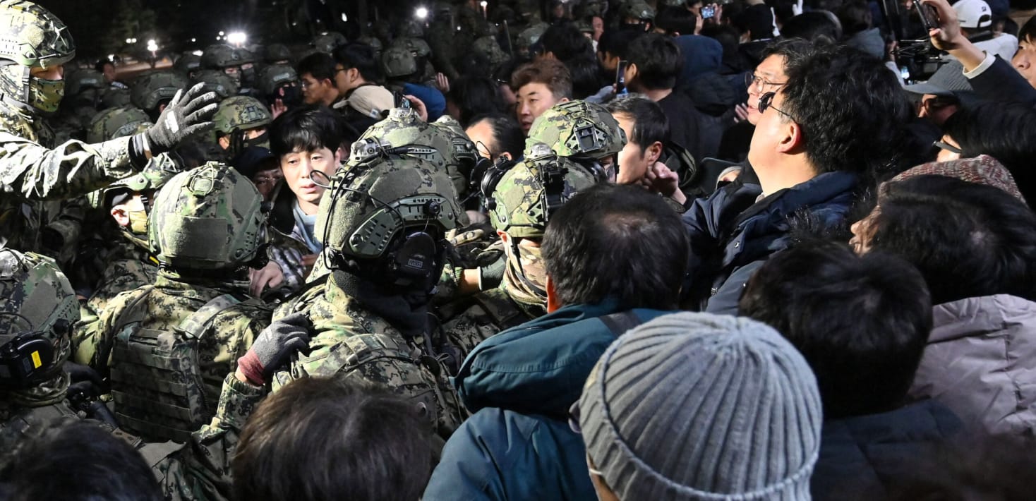 Soldiers try to enter the National Assembly building in Seoul on December 4 2024, after South Korea President Yoon Suk Yeol declared martial law. South Korea's President Yoon Suk Yeol on December 3 declared martial law, accusing the opposition of being 