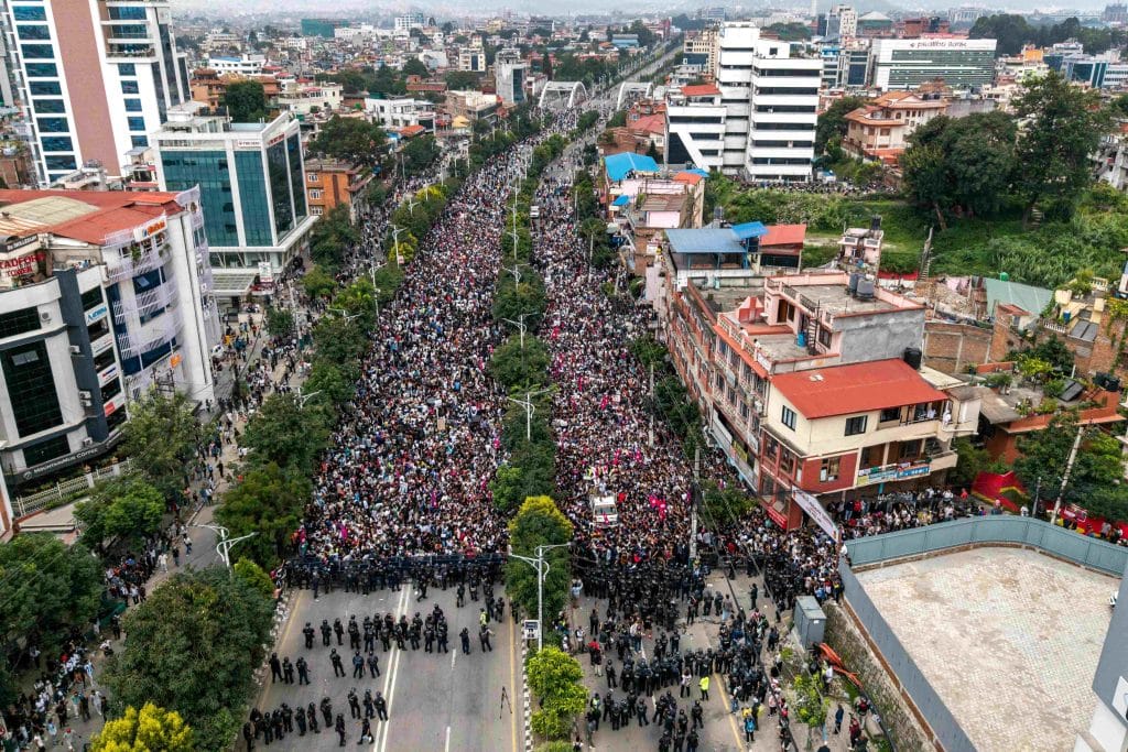 TOPSHOT - An aerial view shows demonstrators gathered outside Nepal's Parliament during a protest in Kathmandu on September 8, 2025, condemning social media prohibitions and corruption by the government. Nepal police on September 8 opened fire, killing at least 17 people as thousands of young protesters took to the streets of Kathmandu demanding the government lift a social media ban and tackle corruption. (Photo by PRABIN RANABHAT / AFP) (Photo by PRABIN RANABHAT/AFP via Getty Images)